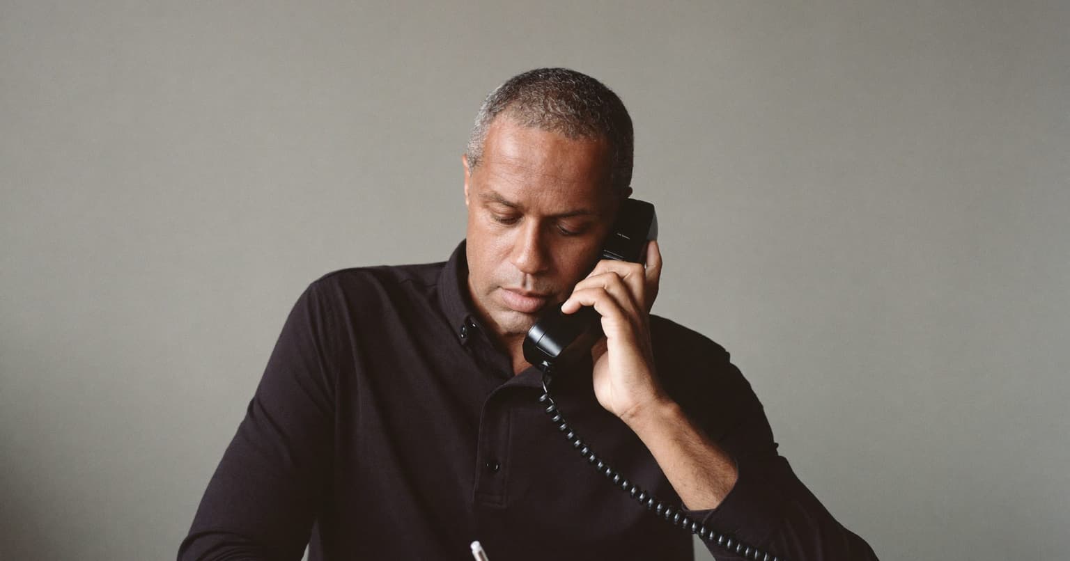 Freelancer on a phone call confirming a request before sending a tax form